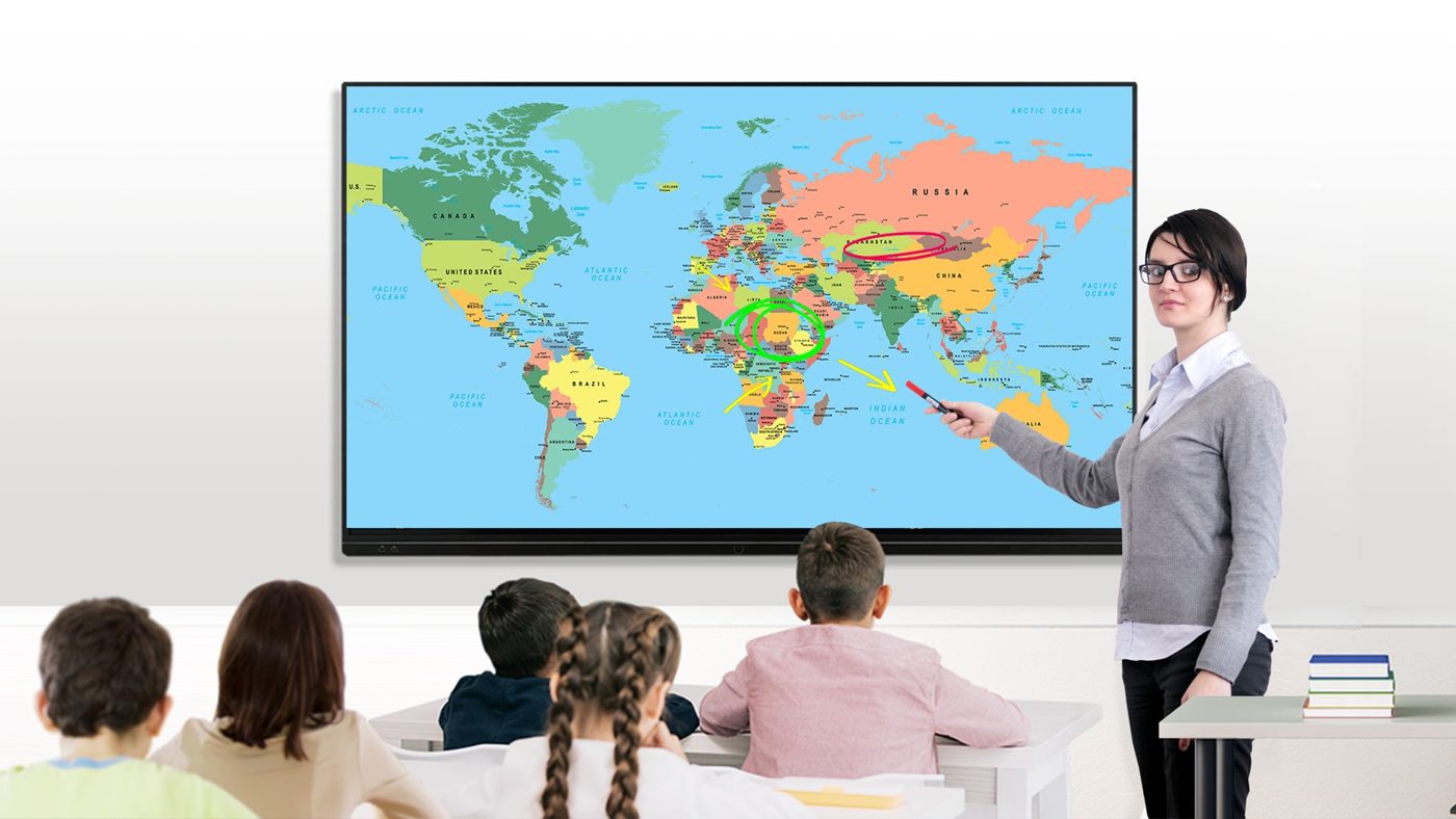 Teacher using an ATVI interactive flat panel in a classroom